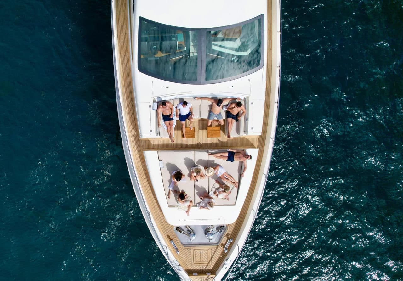 Bow sunpad on ANDREIKA yacht in Cabo San Lucas with guests lounging on teak