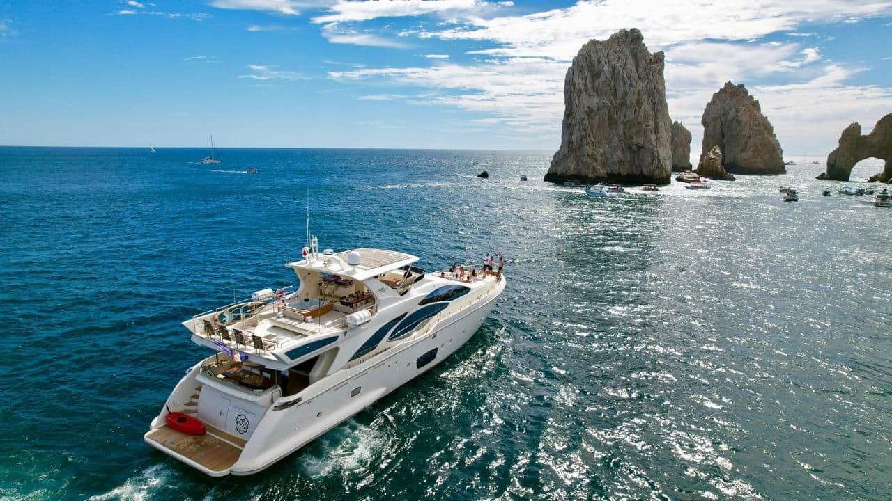 ANDREIKA 95ft Azimut yacht charter cruising past El Arco in Cabo San Lucas, name on the transom