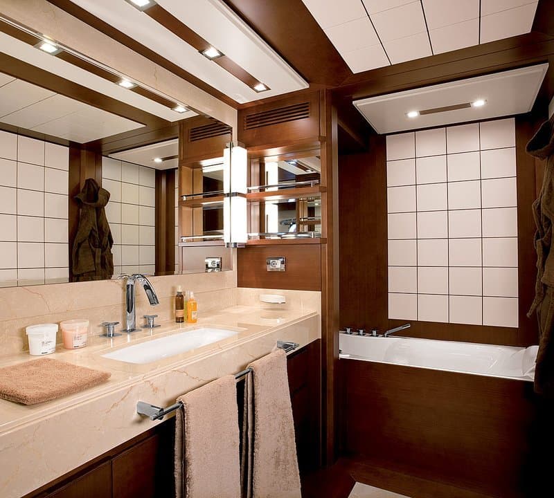 Ensuite bathroom on ANDREIKA 95ft Azimut yacht with marble vanity and tub